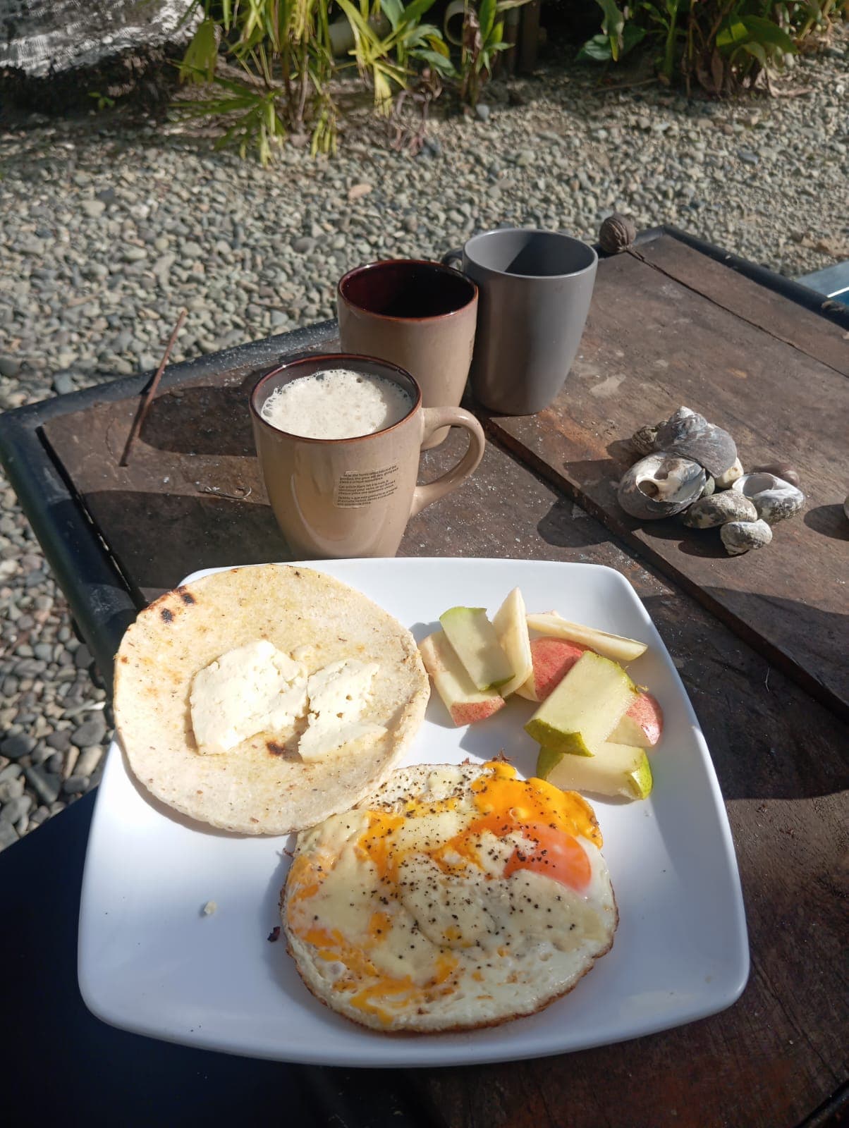 Arepa with fried egg and fruit
